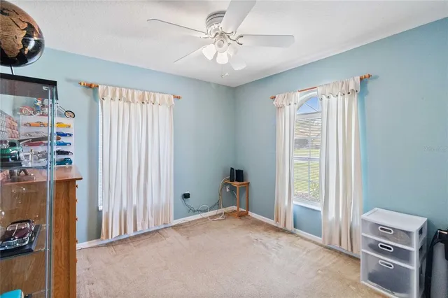 a view of a bedroom with cabinet and a window
