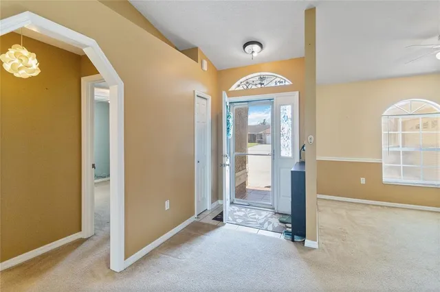 an empty room with a window and a swimming pool