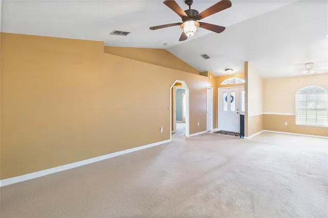 a view of a livingroom with a ceiling fan and window