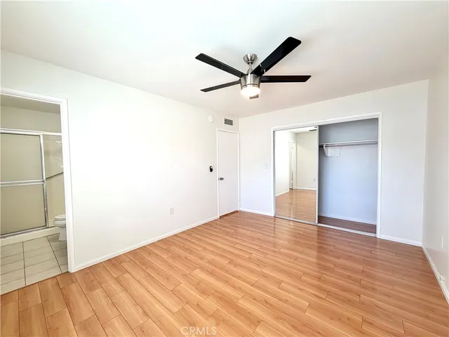 a bathroom with a toilet sink vanity and mirror