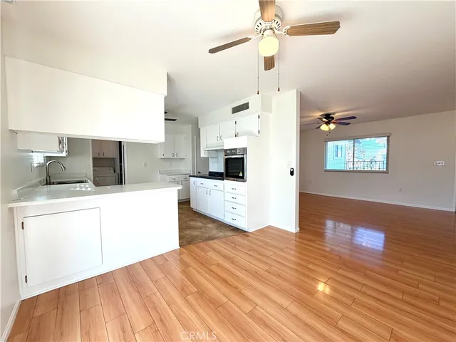 a kitchen view with stainless steel appliances kitchen island granite countertop a sink and a microwave