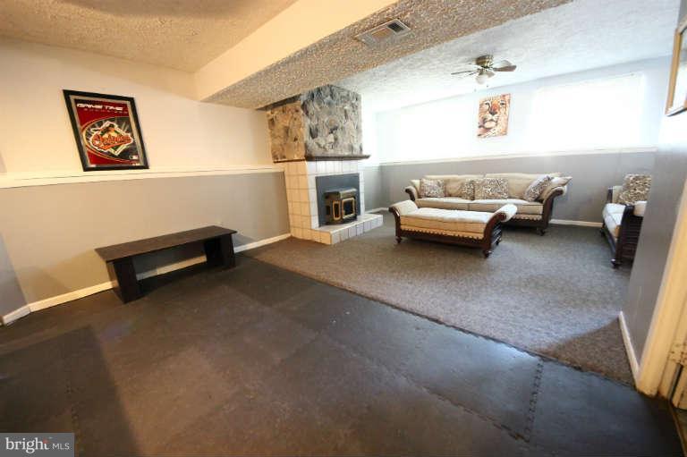 522 Fuselage Avenue Baltimore, MD 21221 - Photo 11 of 16 a living room with furniture and a couch