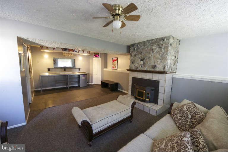 522 Fuselage Avenue Baltimore, MD 21221 - Photo 12 of 16 a living room with furniture and a fireplace