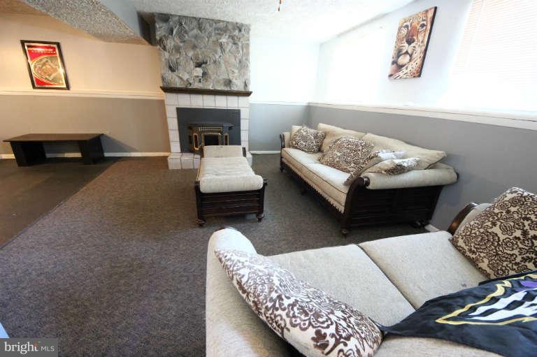 522 Fuselage Avenue Baltimore, MD 21221 - Photo 13 of 16 a living room with furniture and a fireplace
