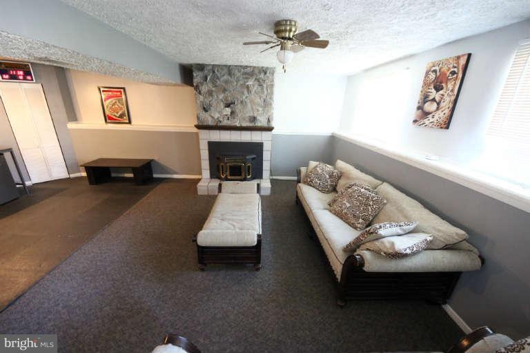 522 Fuselage Avenue Baltimore, MD 21221 - Photo 14 of 16 a living room with furniture and a fireplace