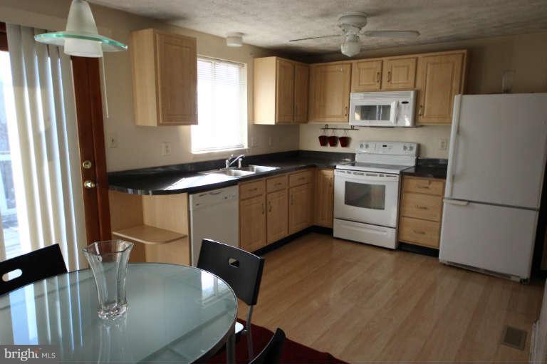 522 Fuselage Avenue Baltimore, MD 21221 - Photo 6 of 16 a kitchen with a stove a sink and a refrigerator