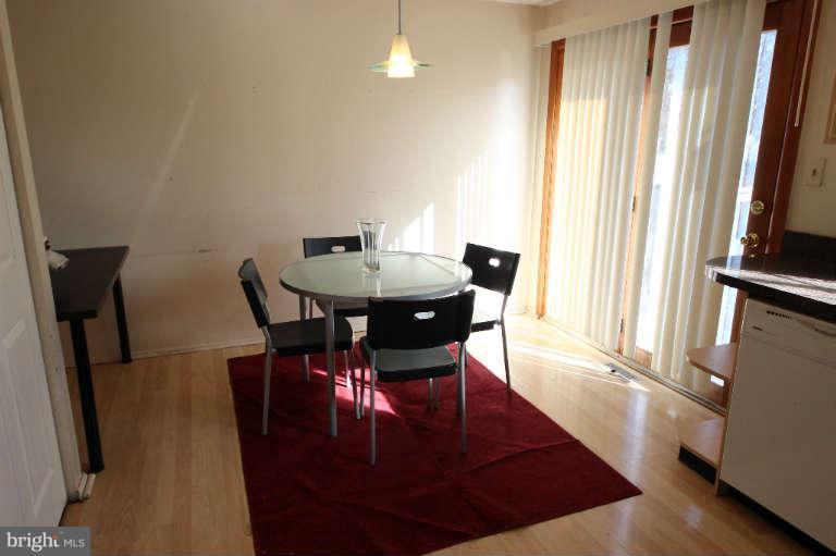 522 Fuselage Avenue Baltimore, MD 21221 - Photo 7 of 16 a view of a dining room with furniture and a window