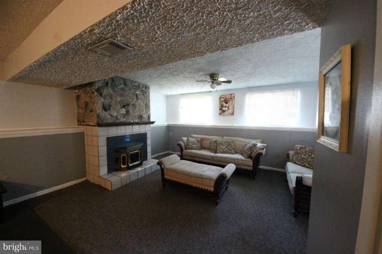 522 Fuselage Avenue Baltimore, MD 21221 - Photo 8 of 16 a living room with furniture and a fireplace