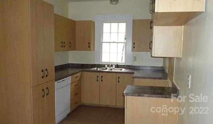 335 South Torrence Street Charlotte, NC 28204 - Photo 3 of 6 a kitchen with a sink a stove and cabinets