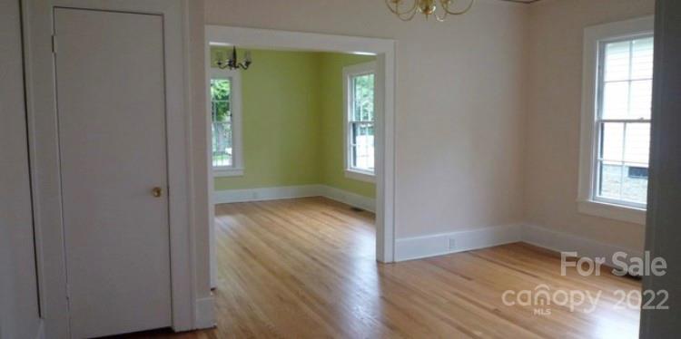 335 South Torrence Street Charlotte, NC 28204 - Photo 5 of 6 an empty room with wooden floor and windows