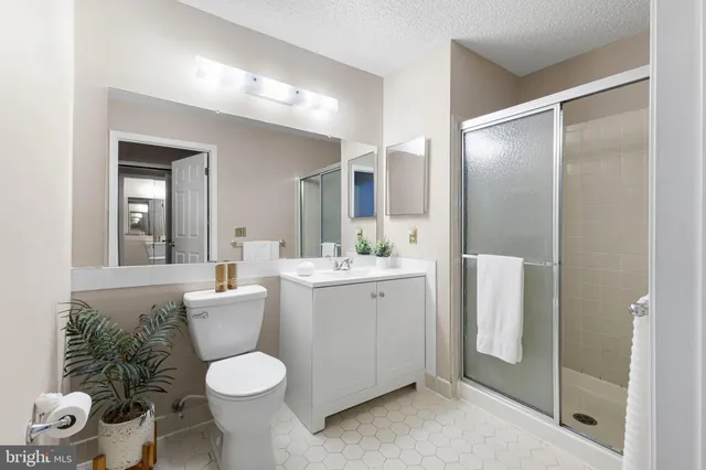 a bathroom with a toilet sink and shower