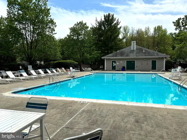 a view of a house with swimming pool and sitting area