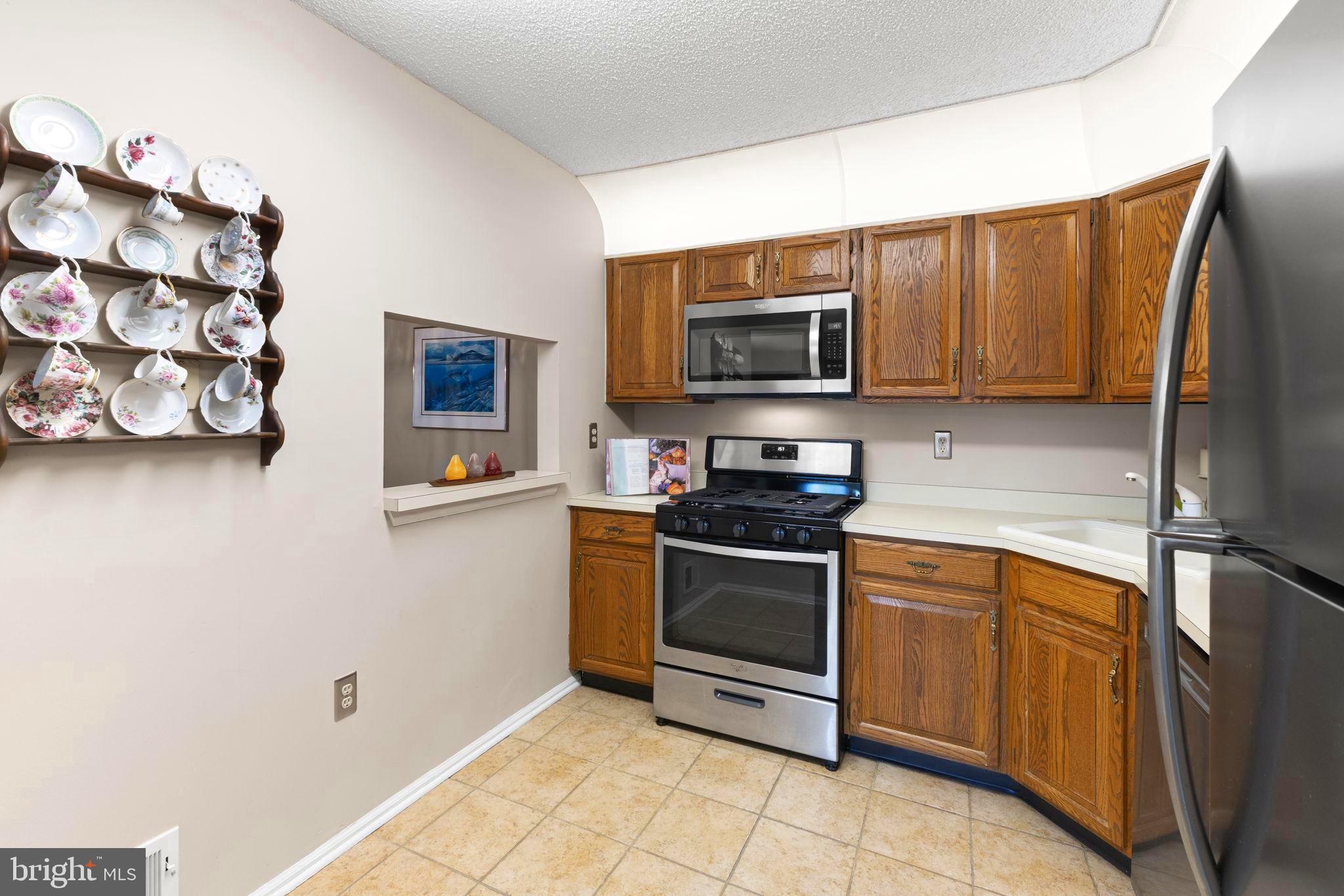 14 Cheverny Court Hamilton, NJ 08619 - Photo 4 of 25 a kitchen with stainless steel appliances granite countertop a refrigerator stove and microwave