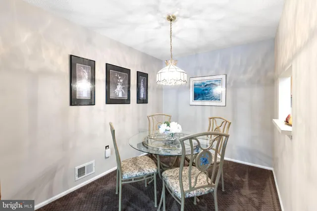 a view of a dining room with furniture wooden floor and chandelier