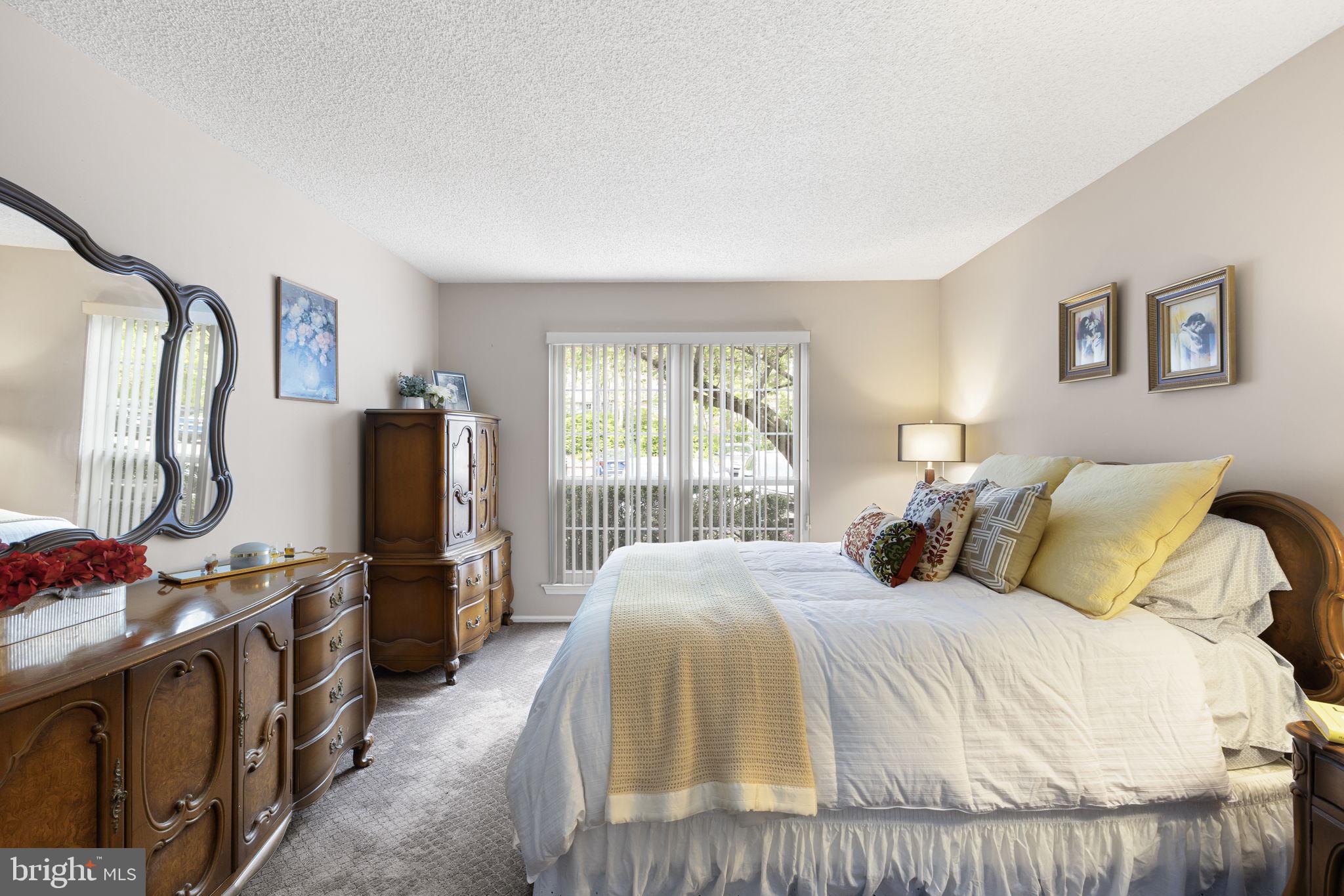 14 Cheverny Court Hamilton, NJ 08619 - Photo 10 of 25 a bedroom with a bed and a flat tv screen on the dresser