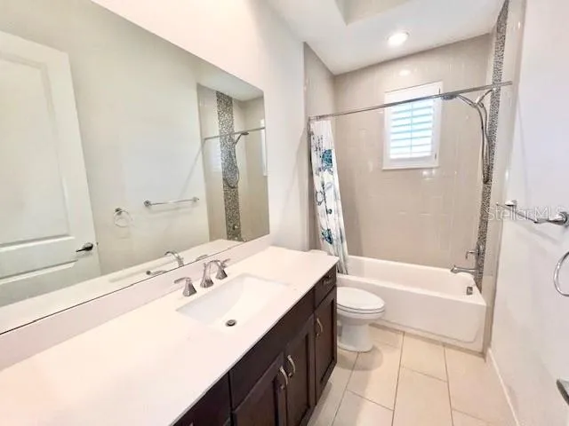 a bathroom with a double vanity sink toilet mirror and bathtub