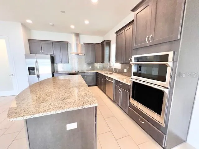 a kitchen with stainless steel appliances granite countertop a sink stove and oven