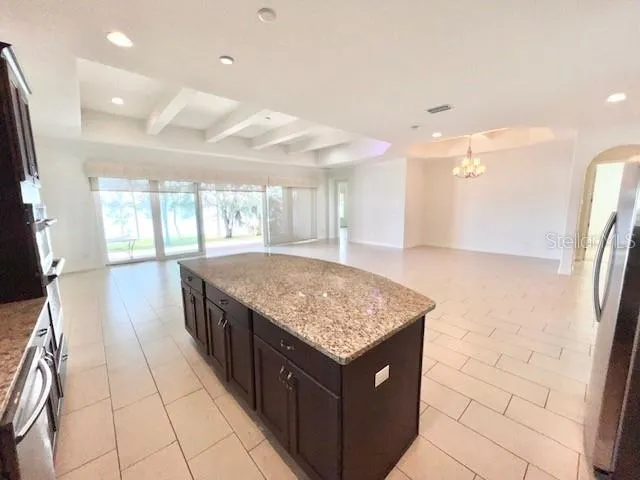 a kitchen with stainless steel appliances granite countertop a sink and a stove