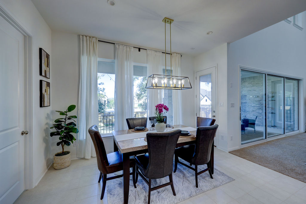 351 Pigeon River Road Kyle, TX 78640 - Photo 13 of 40 Dining area with a chandelier and light carpet