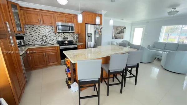 a dining hall with stainless steel appliances a table and chairs