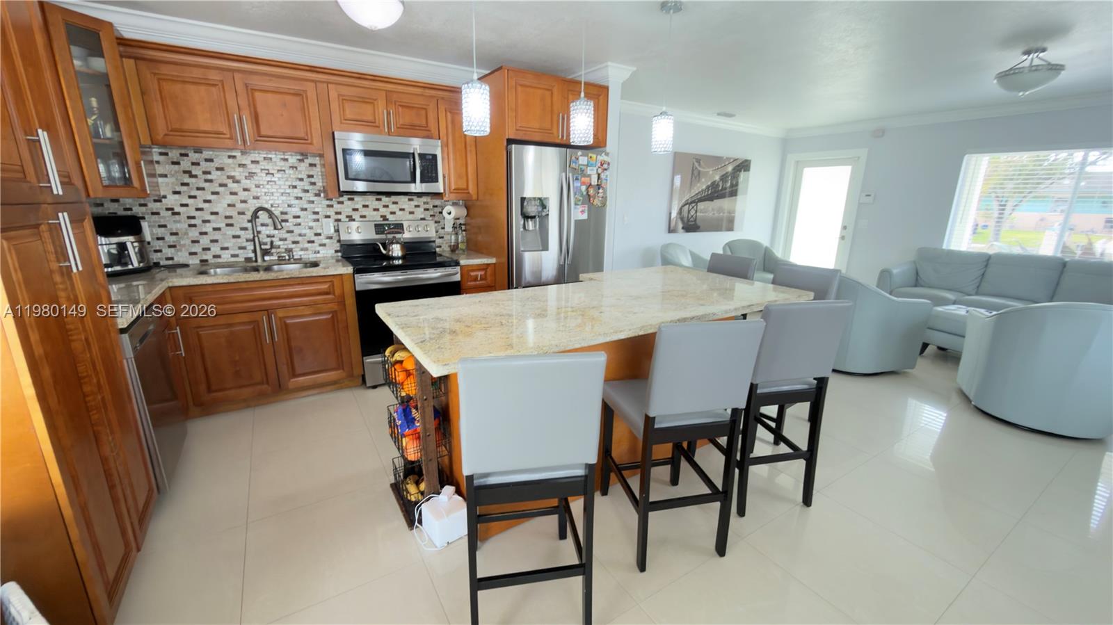 30001 Southwest 153rd Avenue Homestead, FL 33033 - Photo 13 of 55 a dining hall with stainless steel appliances a table and chairs