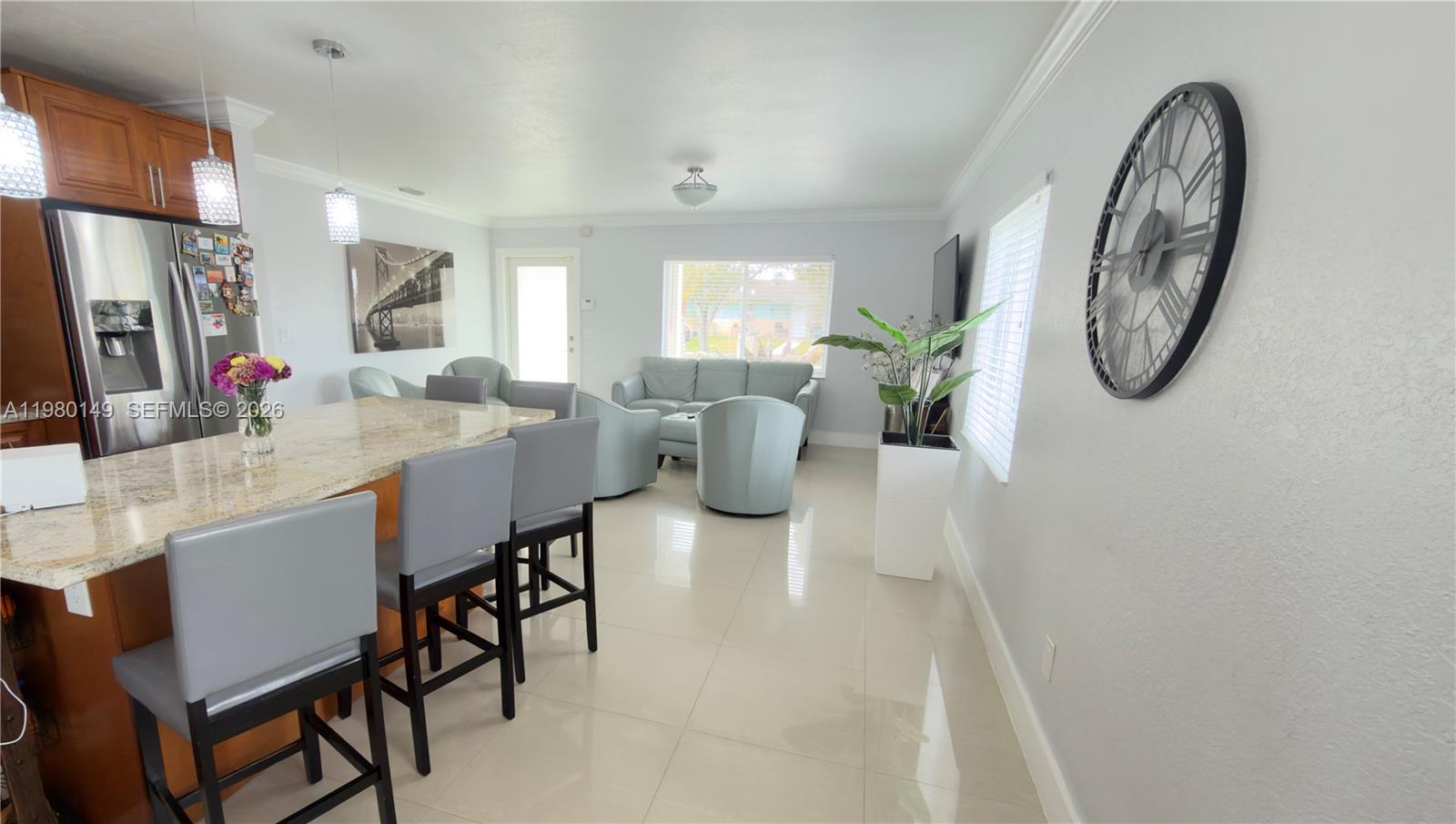 30001 Southwest 153rd Avenue Homestead, FL 33033 - Photo 15 of 55 a dining room with furniture a mirror and a chandelier