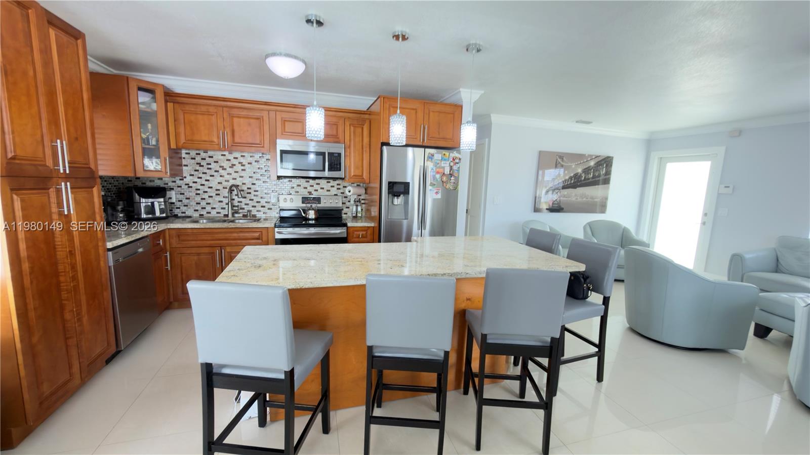 30001 Southwest 153rd Avenue Homestead, FL 33033 - Photo 18 of 55 a dining room with furniture a large window and stainless steel appliances