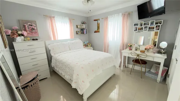 a bedroom with a bed and flat screen tv