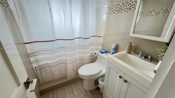 a bathroom with a sink toilet and a mirror