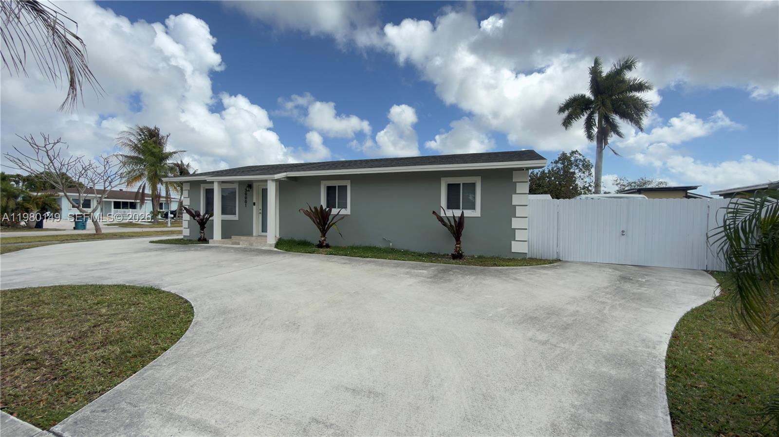 30001 Southwest 153rd Avenue Homestead, FL 33033 - Photo 4 of 55 front view of house with a yard and potted plants
