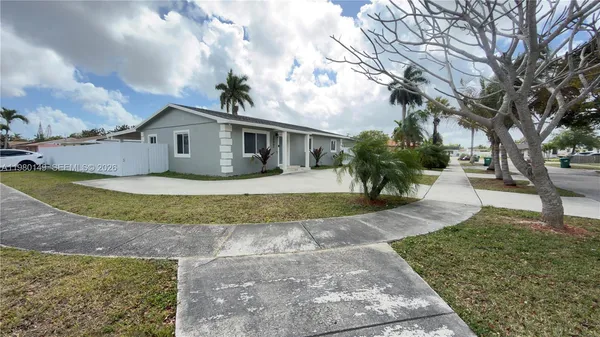 a front view of a house with a yard and a garage