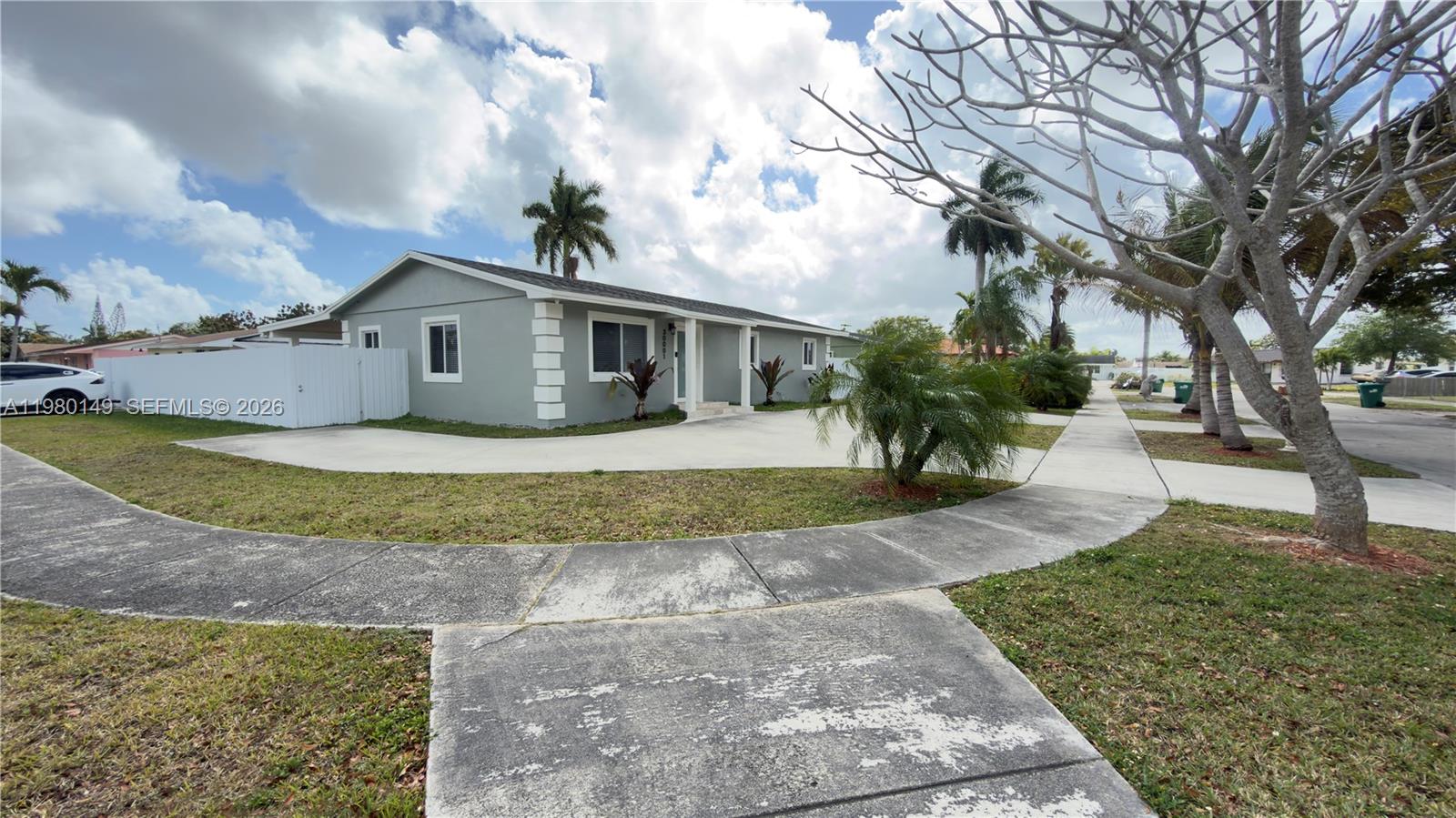 30001 Southwest 153rd Avenue Homestead, FL 33033 - Photo 7 of 55 a front view of a house with a yard and a garage