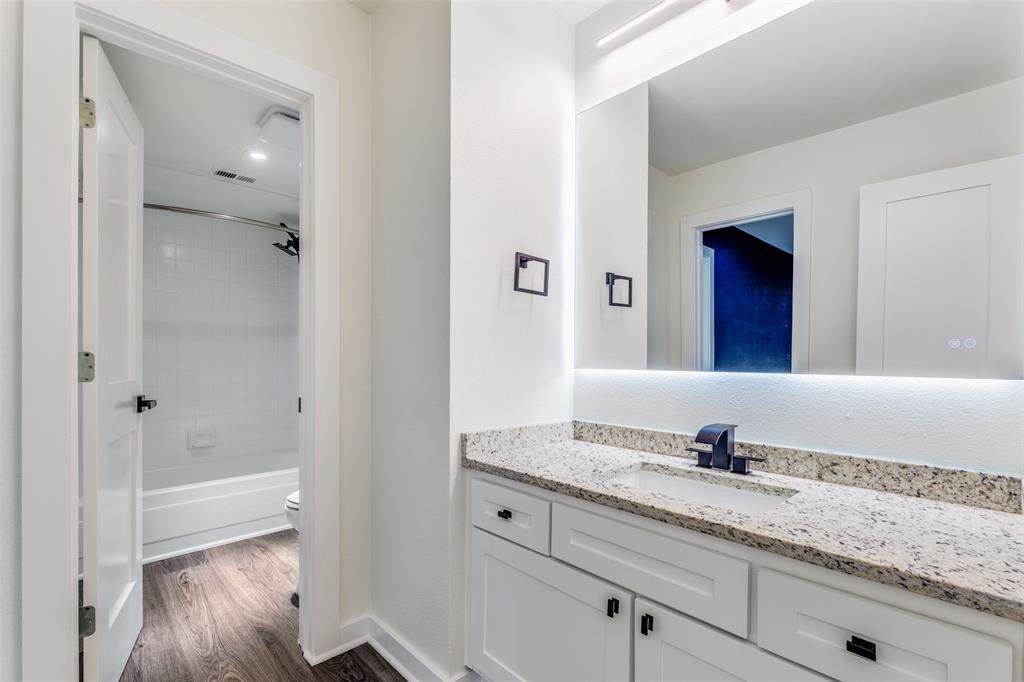 2228 Colony Court Dallas, TX 75235 - Photo 12 of 14 a bathroom with a granite countertop sink and mirror