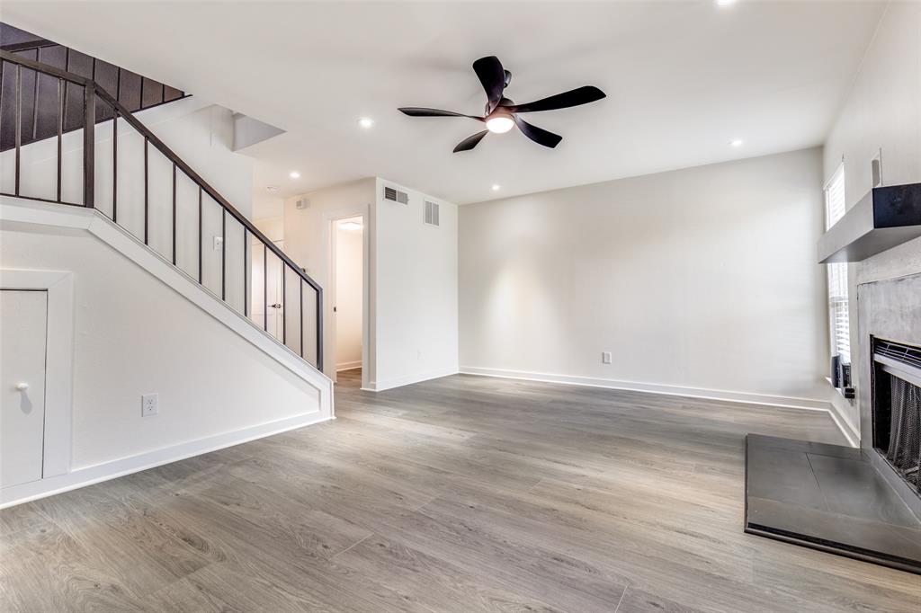 2228 Colony Court Dallas, TX 75235 - Photo 3 of 14 a view of an empty room with wooden floor and a ceiling fan