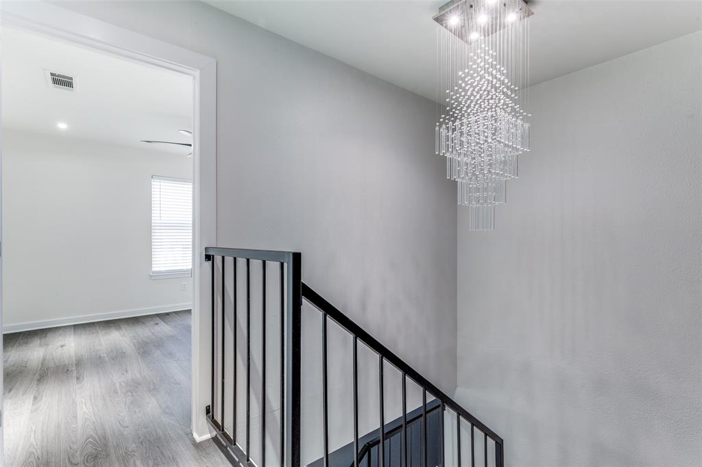 2228 Colony Court Dallas, TX 75235 - Photo 8 of 14 a view of a hallway to a room with wooden floor