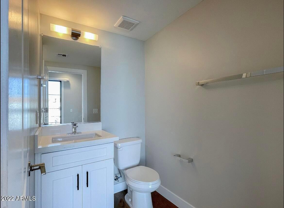 3215 East Flower Street, Unit 10 Phoenix, AZ 85018 - Photo 18 of 50 a bathroom with a sink mirror toilet and vanity