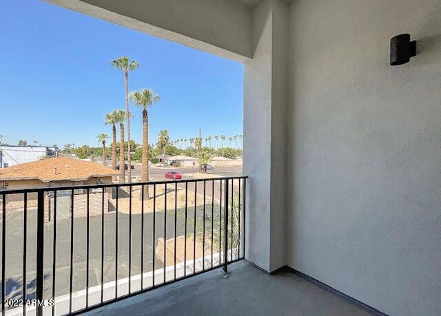 3215 East Flower Street, Unit 10 Phoenix, AZ 85018 - Photo 23 of 50 a view of a balcony with a chair and wooden floor