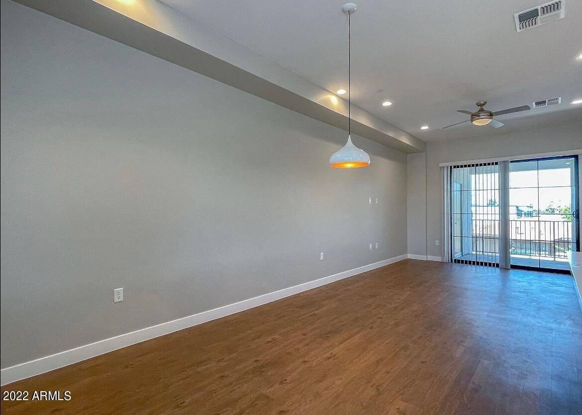 3215 East Flower Street, Unit 10 Phoenix, AZ 85018 - Photo 25 of 50 a view of an empty room with glass door and fan