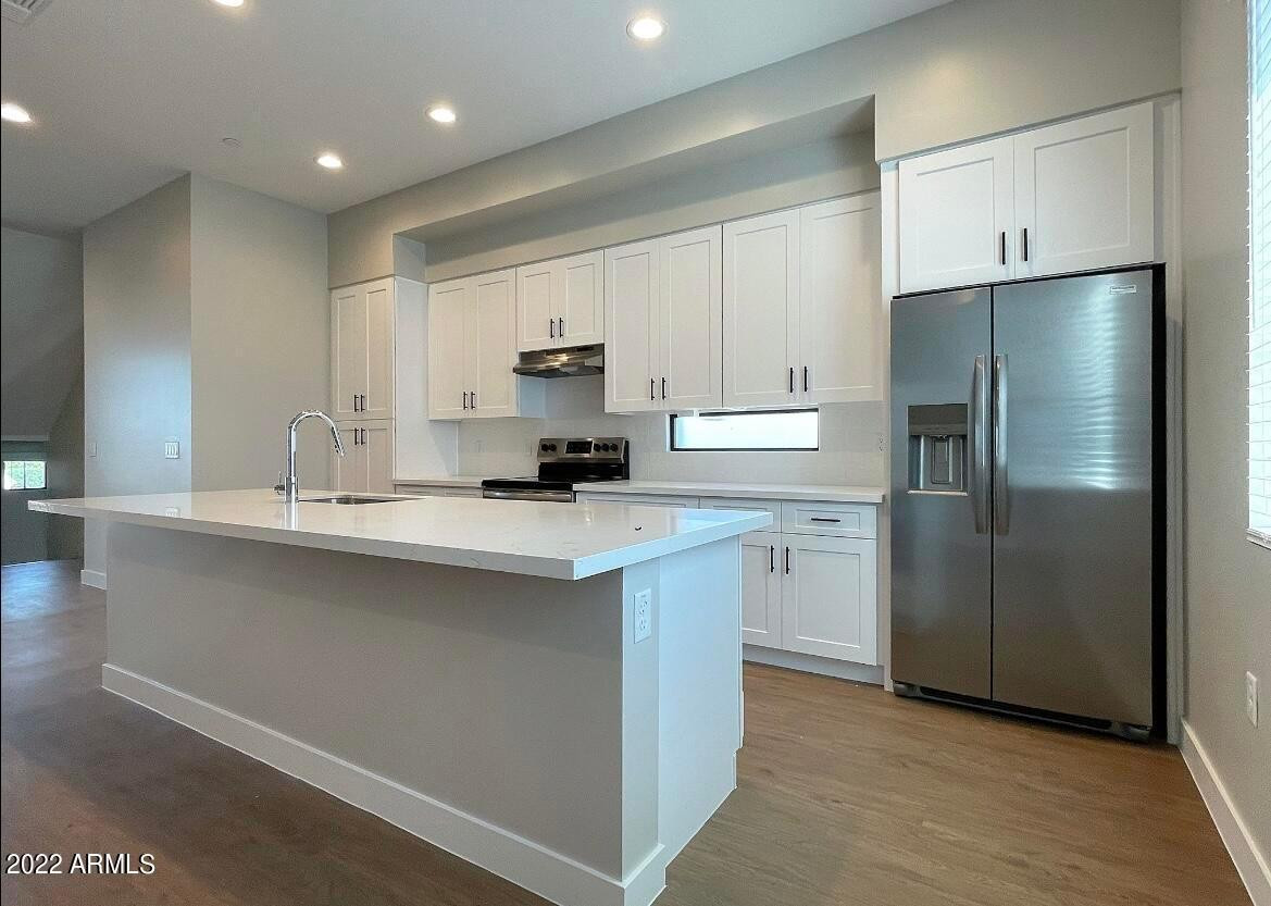 3215 East Flower Street, Unit 10 Phoenix, AZ 85018 - Photo 26 of 50 a kitchen with a refrigerator sink and cabinets