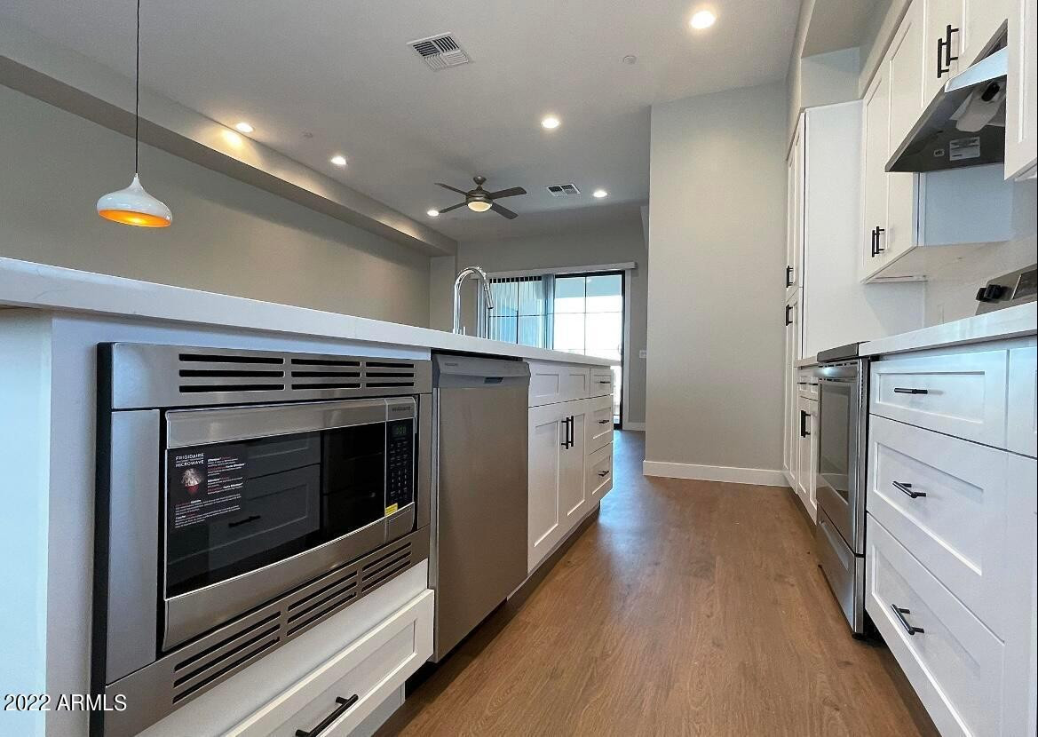 3215 East Flower Street, Unit 10 Phoenix, AZ 85018 - Photo 29 of 50 a view of an empty room with kitchen and a window