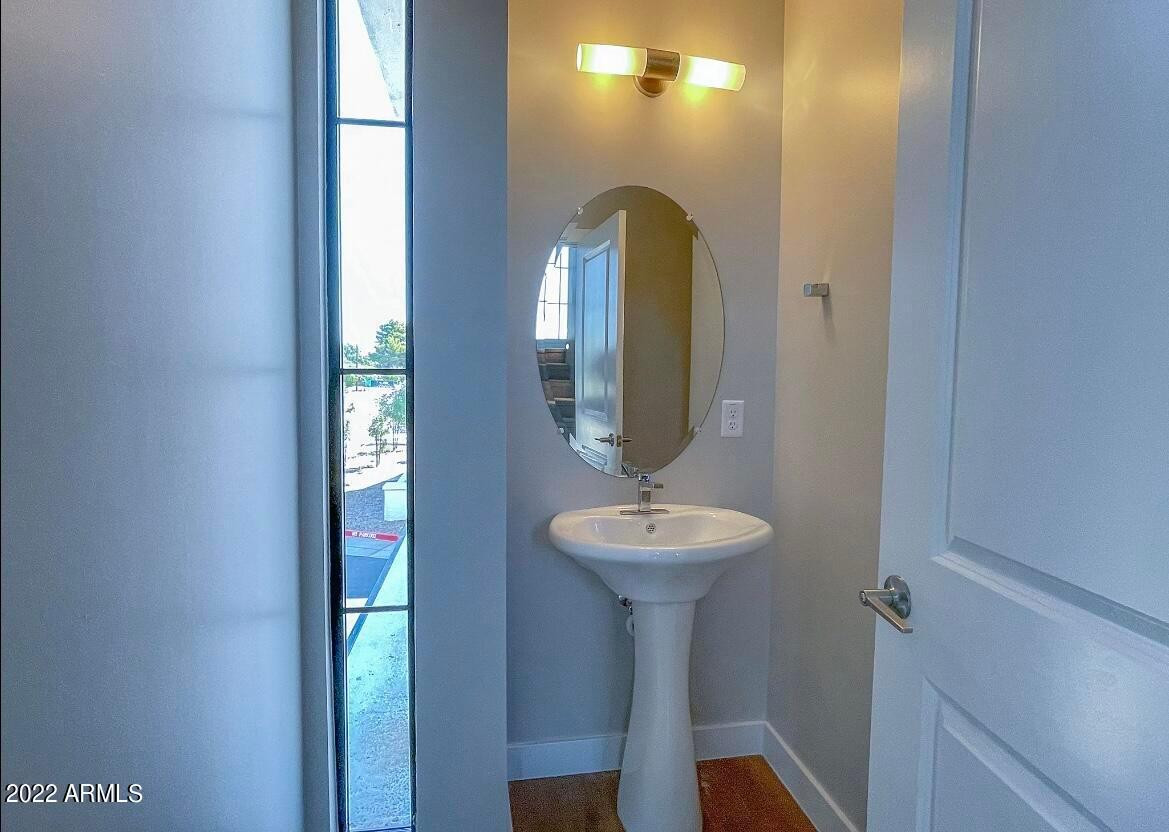 3215 East Flower Street, Unit 10 Phoenix, AZ 85018 - Photo 39 of 50 a view of a bathroom with a sink and mirror
