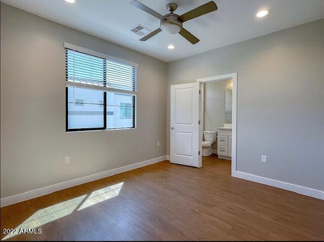 3215 East Flower Street, Unit 10 Phoenix, AZ 85018 - Photo 44 of 50 wooden floor in an empty room with a window