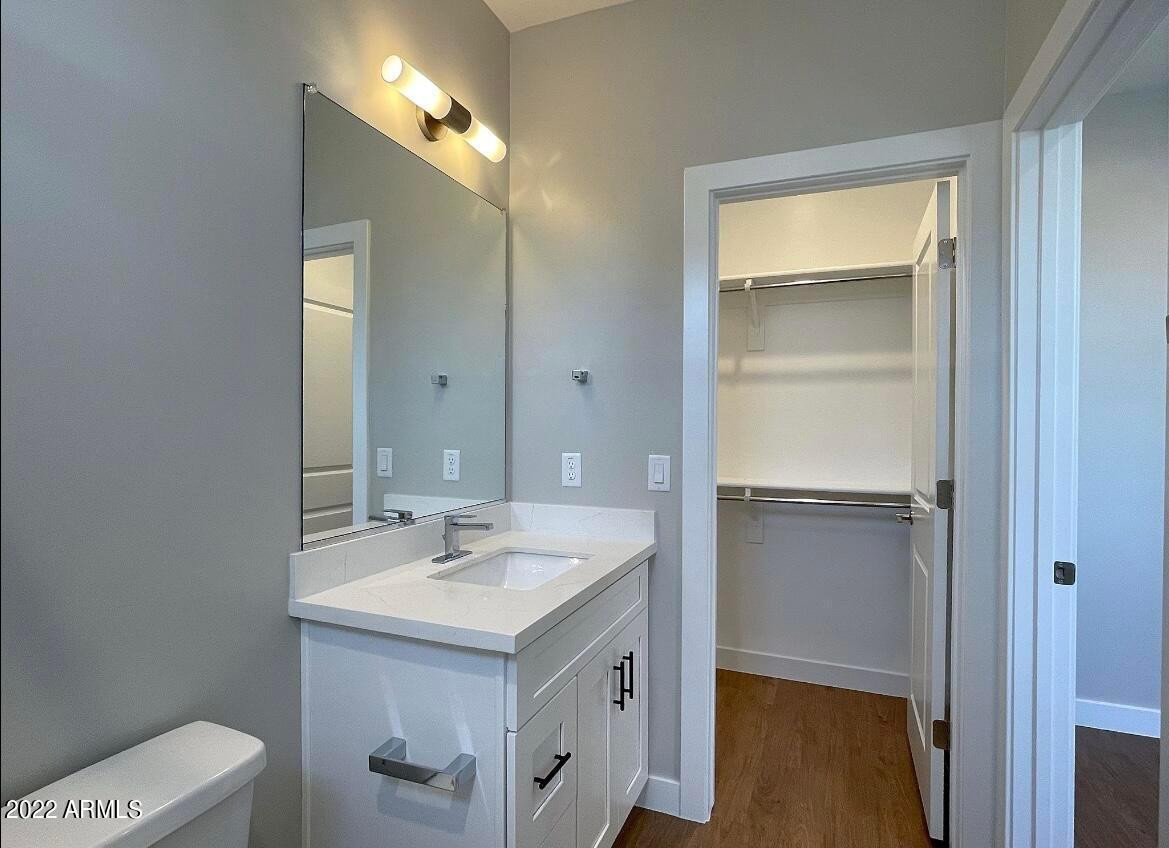 3215 East Flower Street, Unit 10 Phoenix, AZ 85018 - Photo 46 of 50 a bathroom with a sink a toilet and vanity