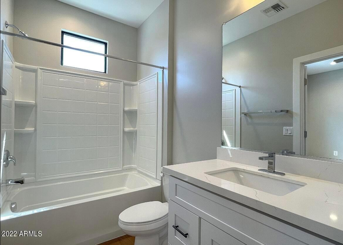 3215 East Flower Street, Unit 10 Phoenix, AZ 85018 - Photo 47 of 50 a bathroom with a granite countertop sink toilet and shower