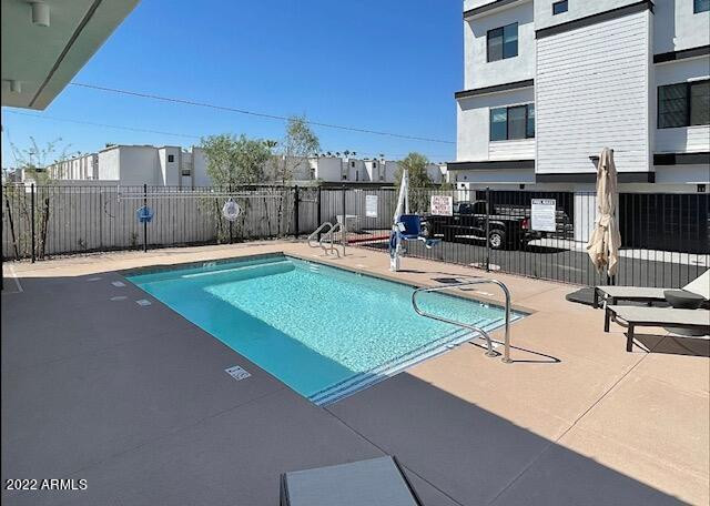 3215 East Flower Street, Unit 10 Phoenix, AZ 85018 - Photo 5 of 50 a swimming pool with outdoor seating and yard