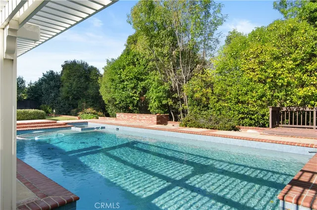 a view of a swimming pool with a yard