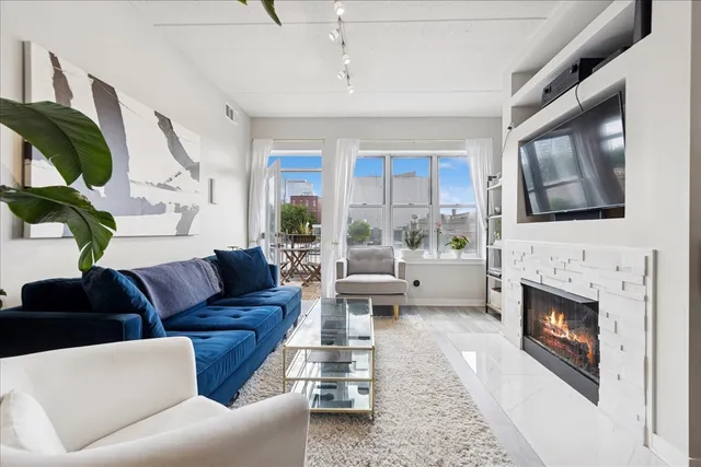 a living room with furniture fireplace and flat screen tv