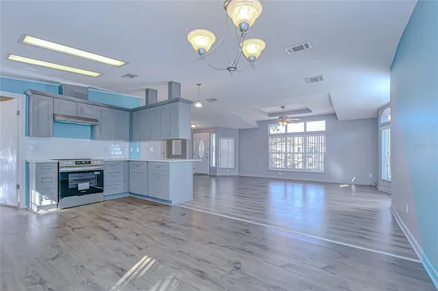 a kitchen with sink cabinets and wooden floor