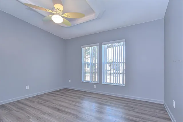 a view of an empty room with wooden floor