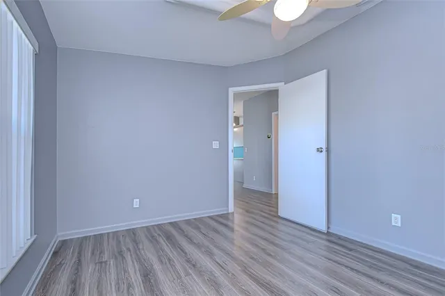 a bathroom with a granite countertop sink a toilet and bathtub